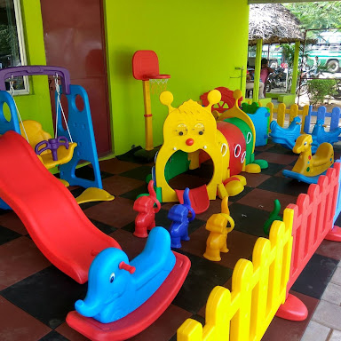 Colorful K square edutainment toys and slides in a vibrant play area.