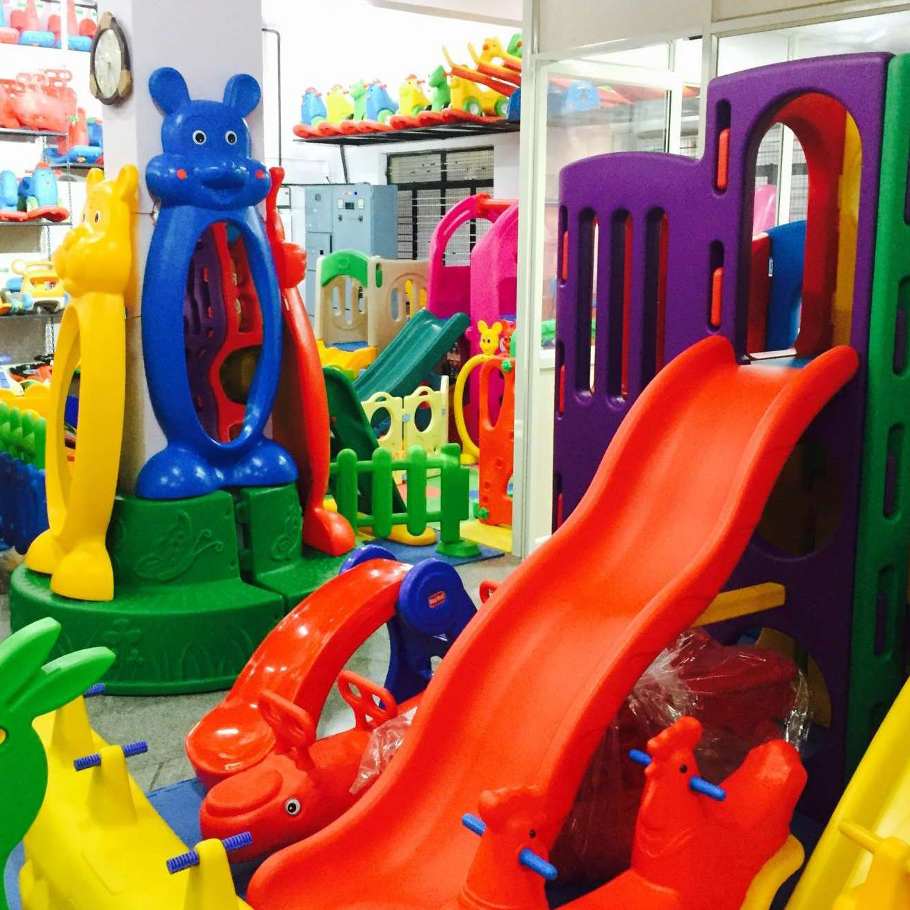 A vibrant play area filled with K square edutainment toys and slides, offering a fun and engaging space for children to play and explore.