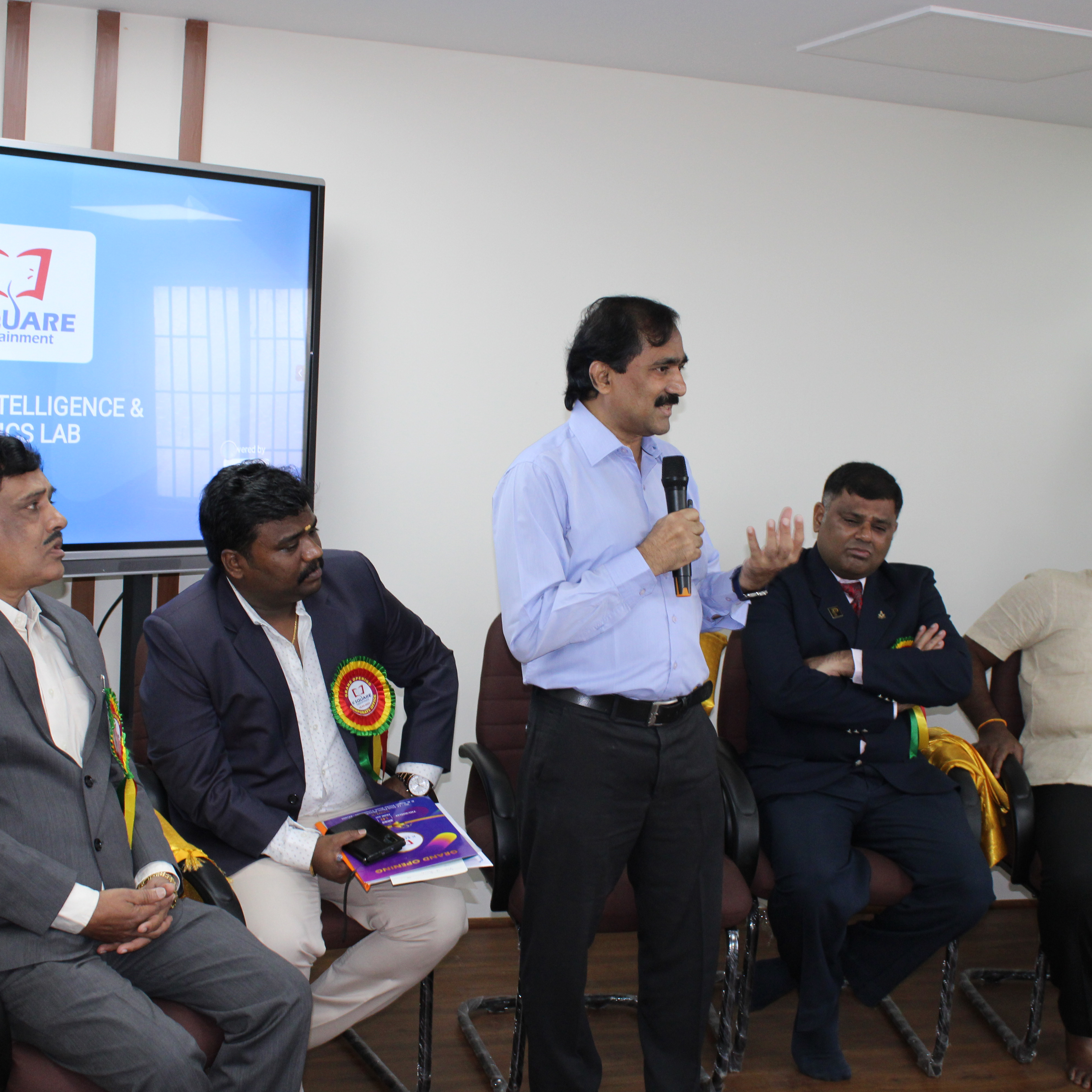 A man addressing the audience with a microphone.