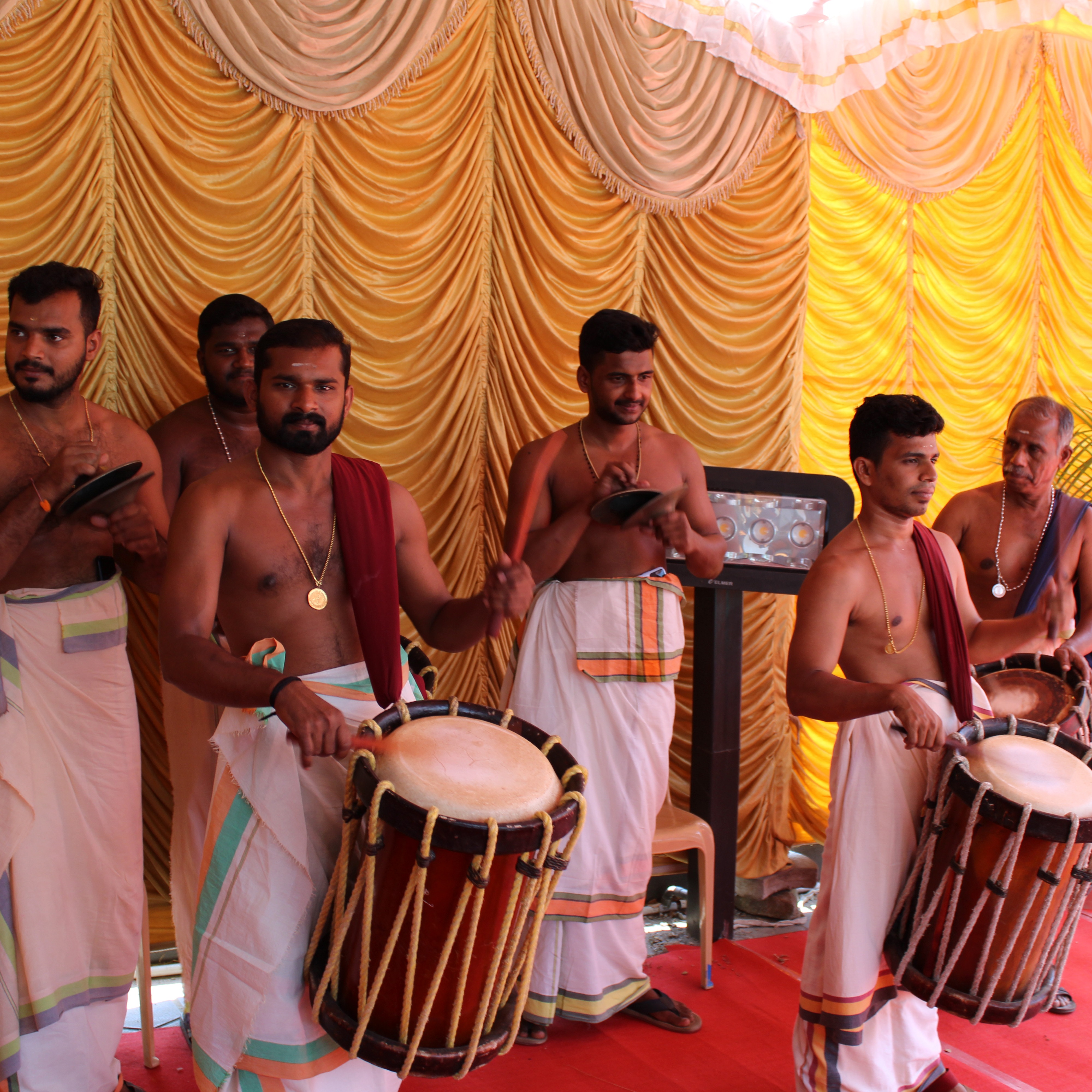 Group of male musicians drumming K square edutainment office innaugration.