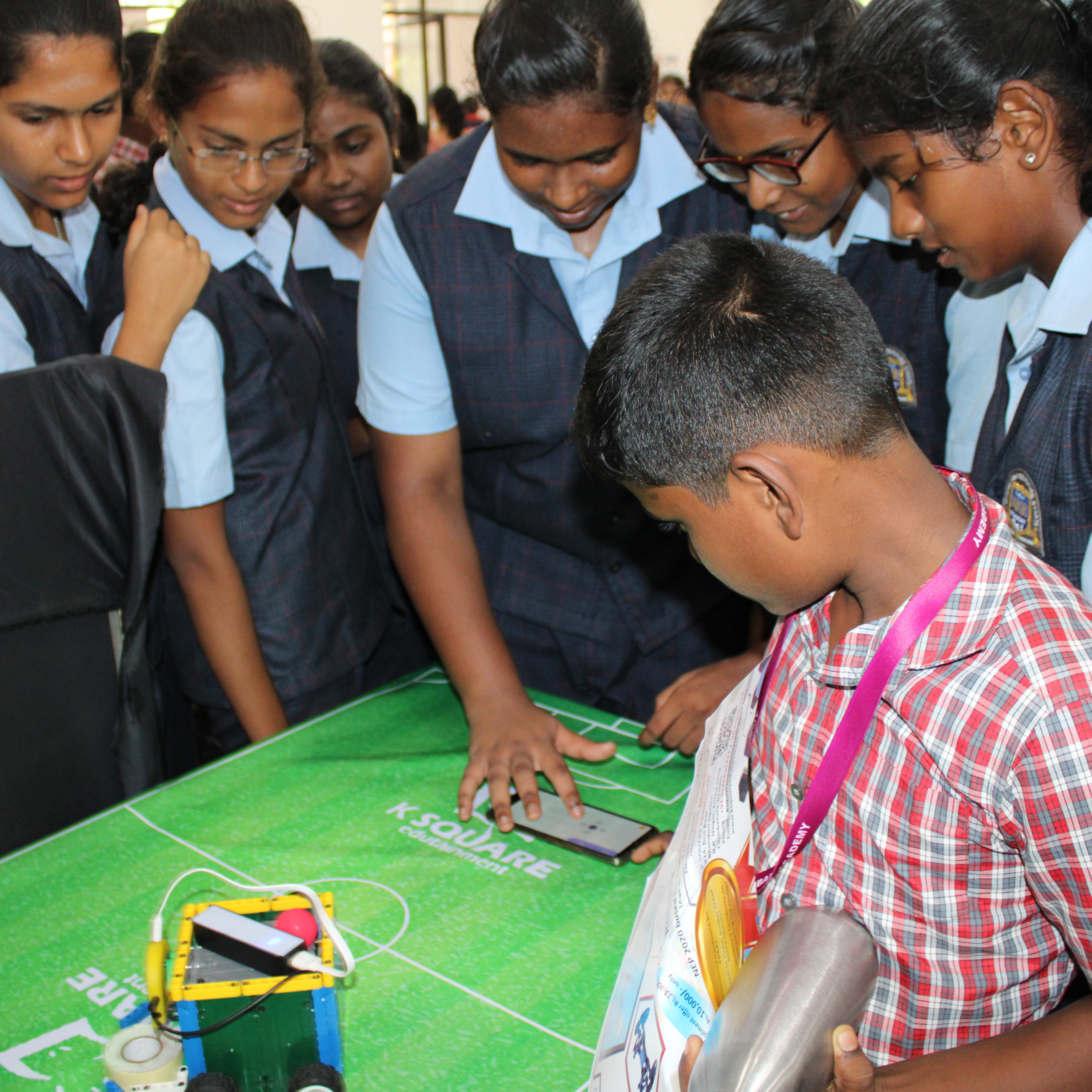 Kids engage with a K square edutainment robot, learning through play, and fostering their curiosity and creativity.