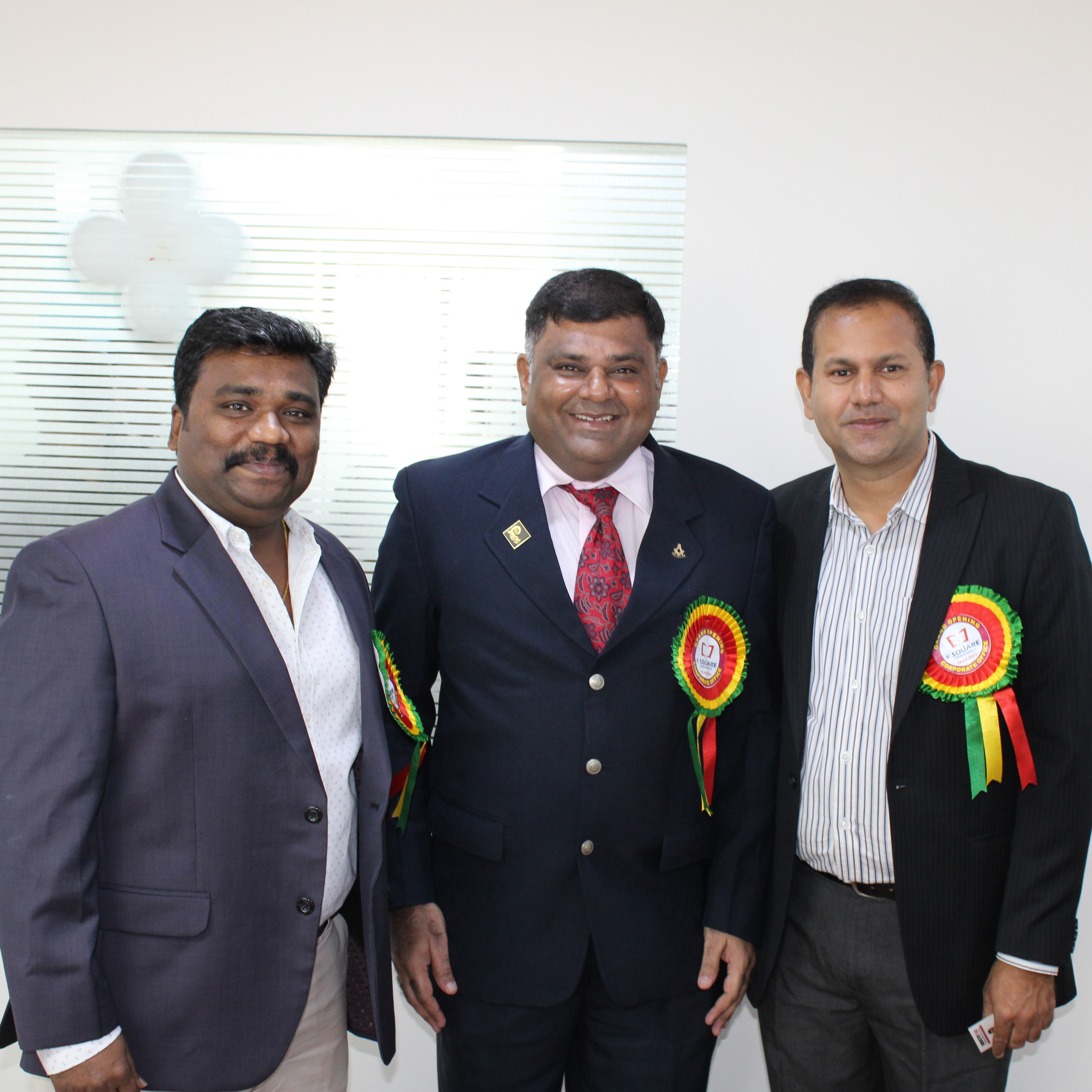 A well-dressed 3 man in a suit posing for a photo.
