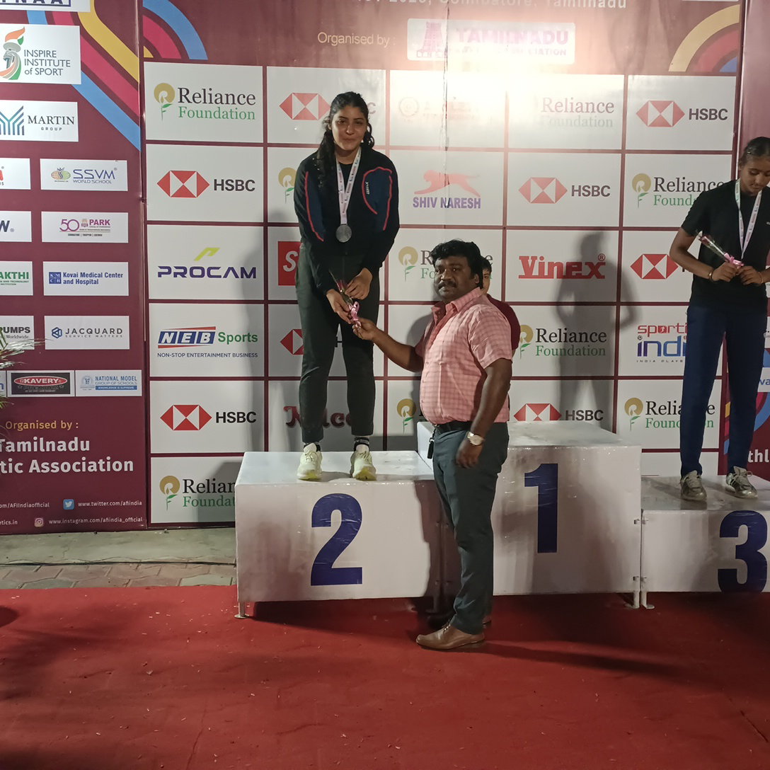 A man distributing price to a girl in a sports event