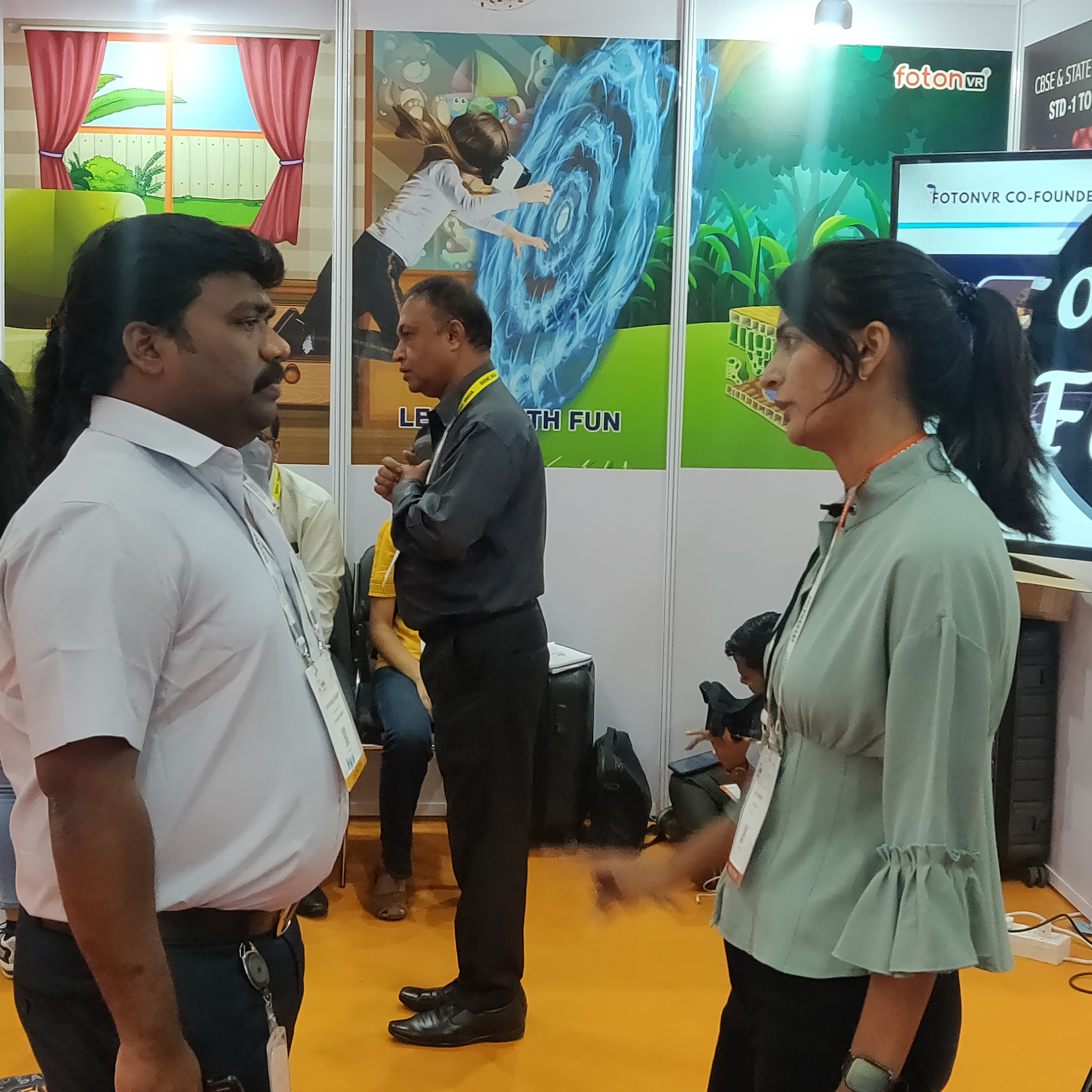 A man and woman discussing in the exhibition.